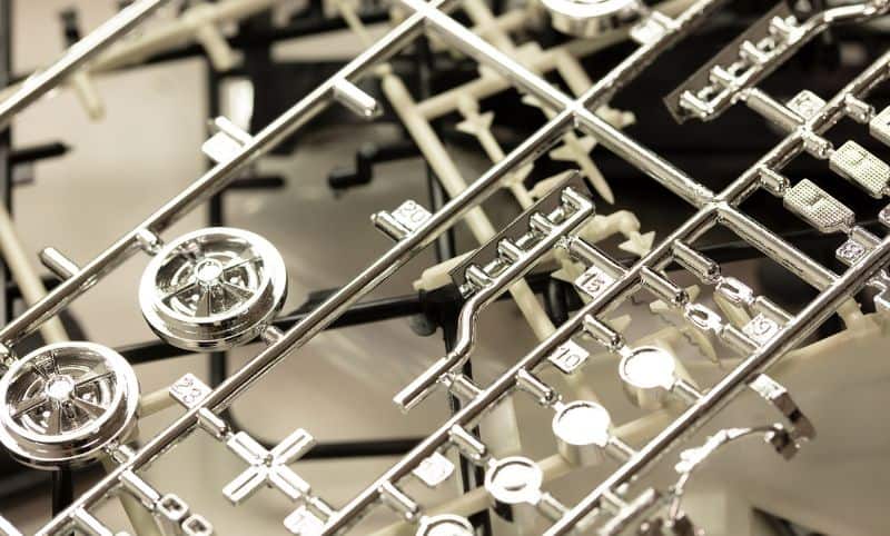 Chrome plastic model parts still attached to runner or sprue.