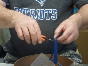 Gate Cutters as demonstrated by an operator trimming injection molded parts free from the gate.